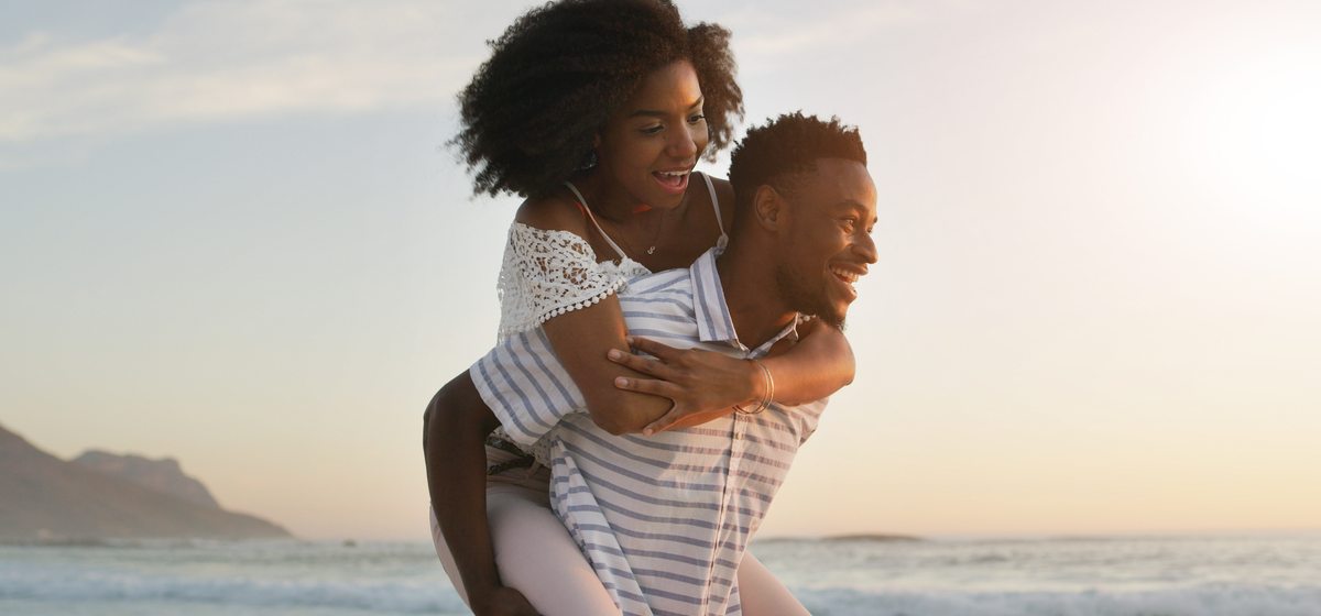 Couple beach piggyback — Caribbean joy
